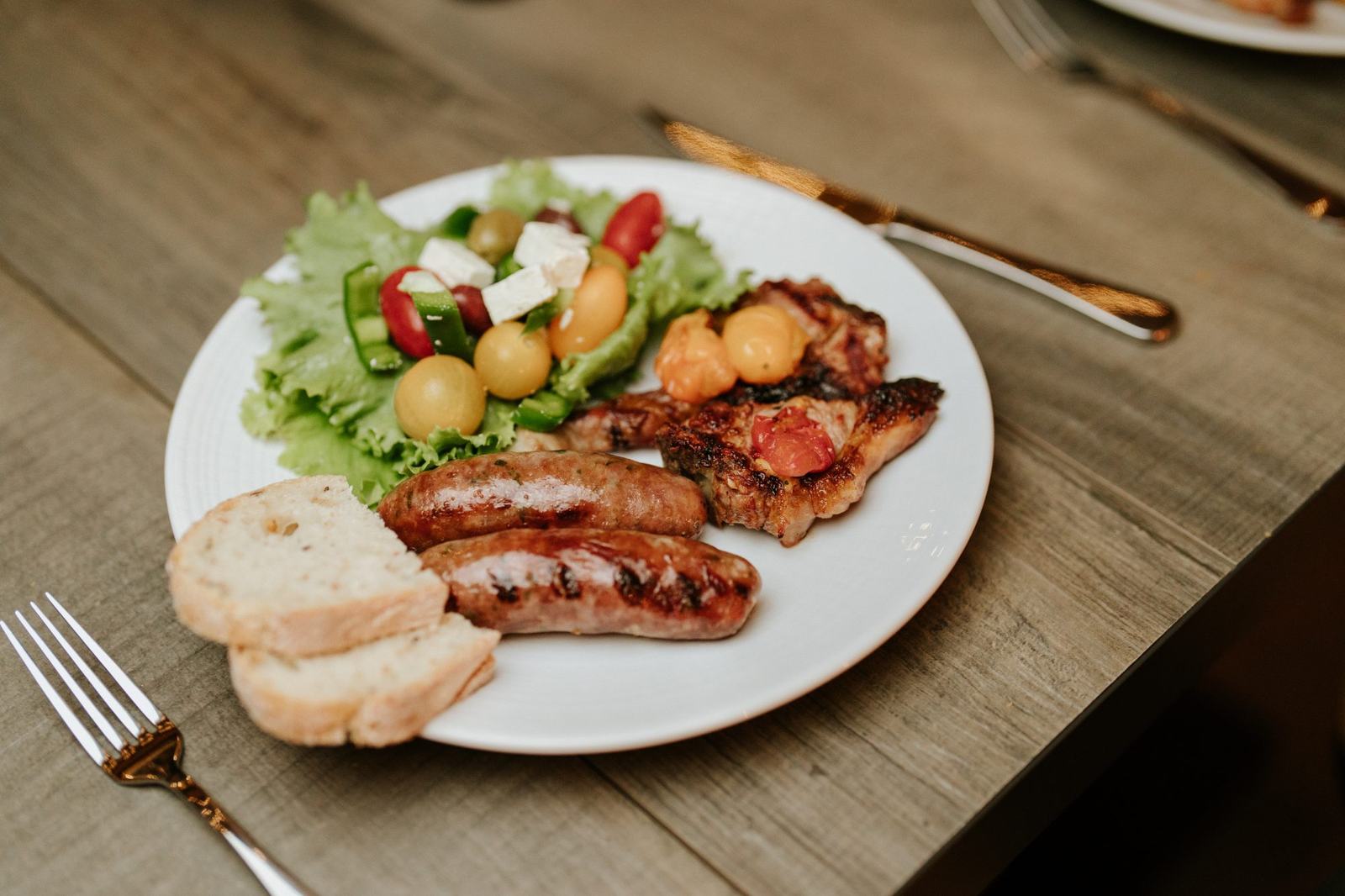 A plated dinner of steak, salad and sourdough