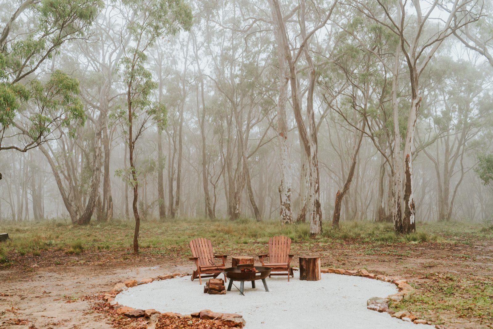 The fire pit and Adirondack chairs in the morning mist