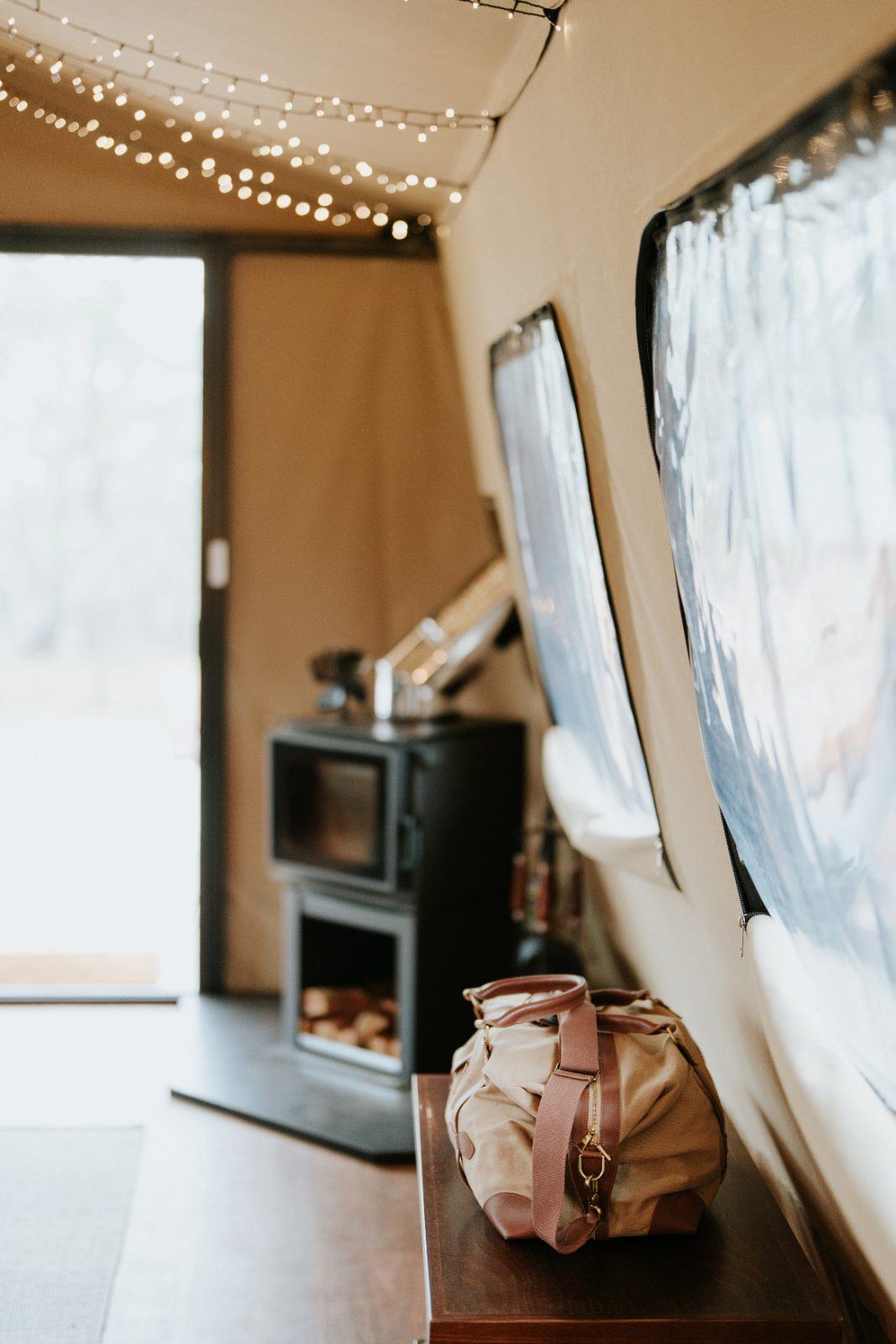 The tent interior with the wood-fire heater glowing