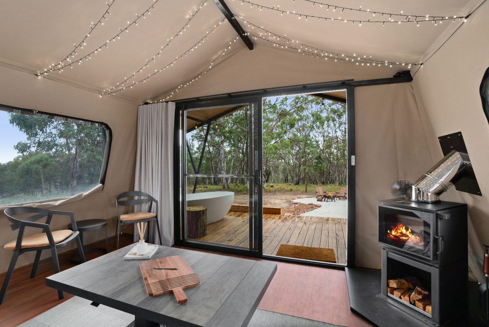 The full tent interior — bed, lounge and fairy lights