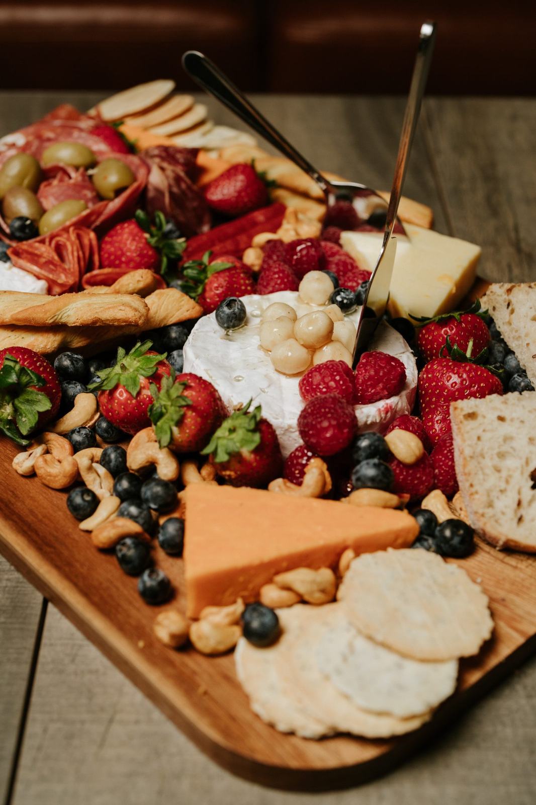 A grazing board of cheese, charcuterie, fruit and crackers